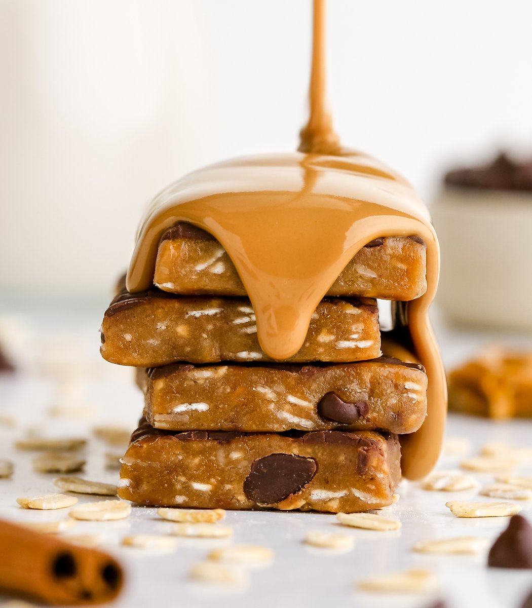 Stack of GoMacro Oatmeal Chocolate Chip Cookie Kids Bars drizzled in peanut butter