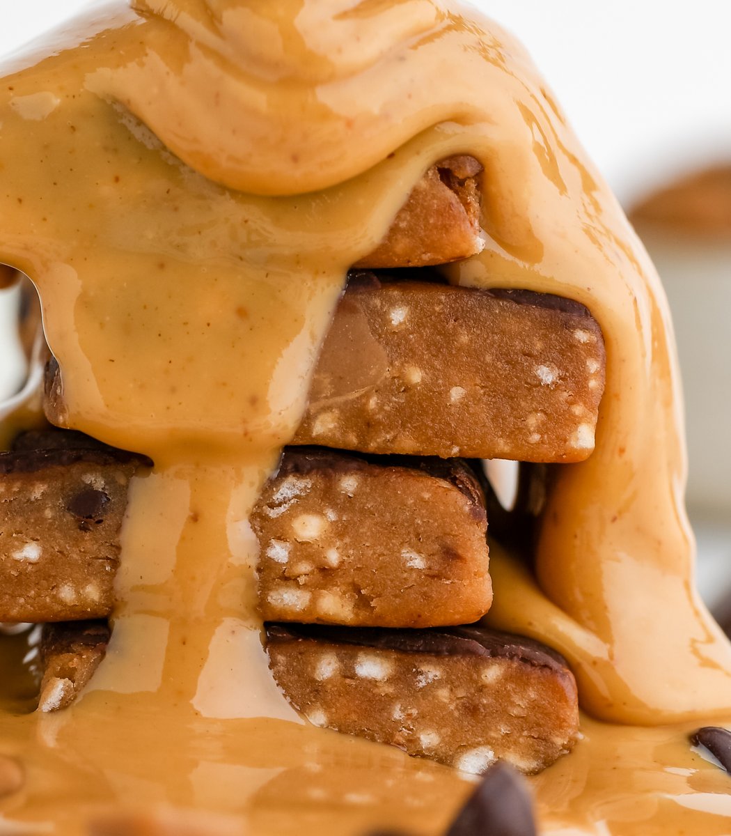 Stack of GoMacro Peanut Butter Cup Kids Bars drizzled in peanut butter