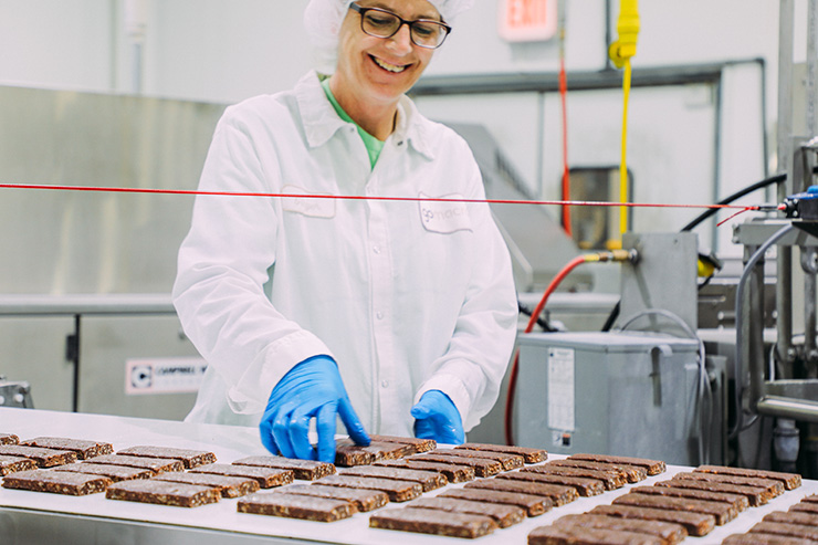 gomacro production line with smiling worker