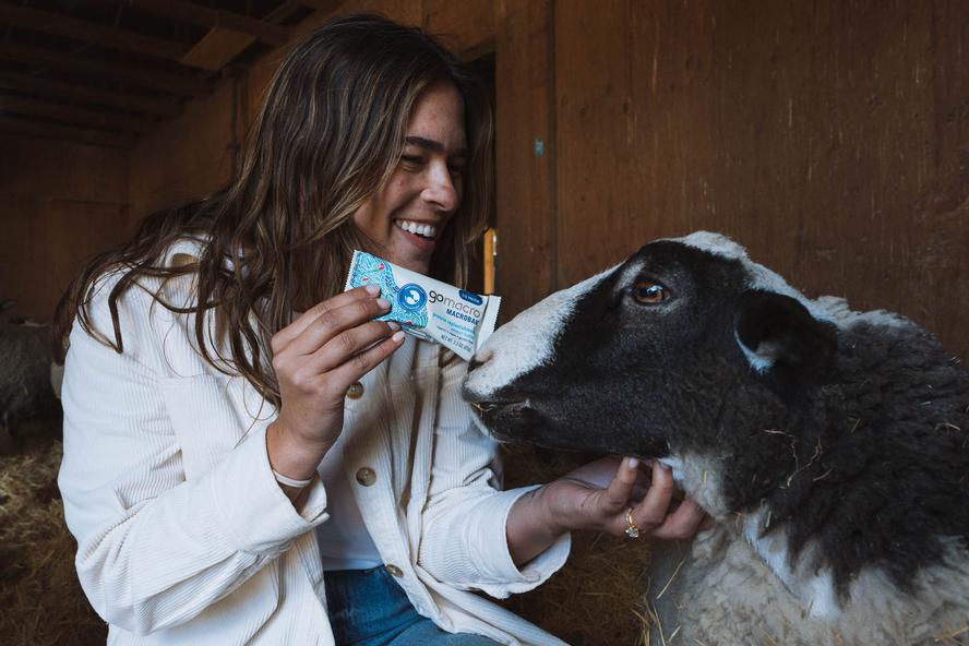 Woman holding GoMacro Peanut Butter MacroBar