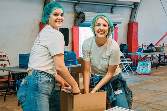 GoMacro employees reaching into box