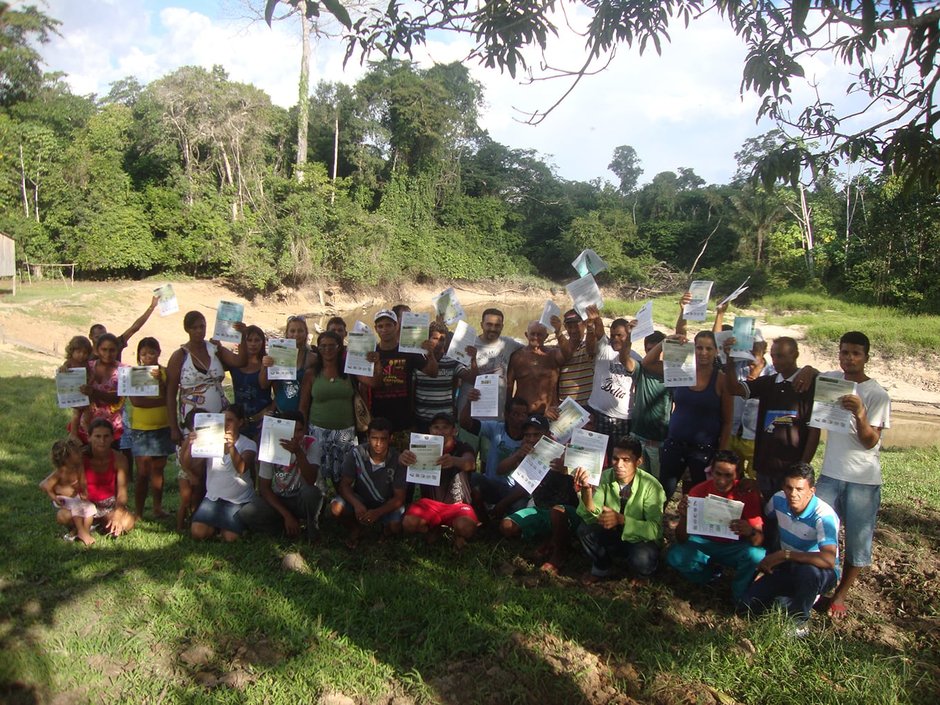 Students in forest holding their certificates