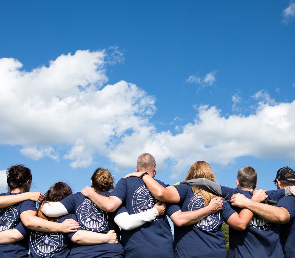 Group with arms around each other