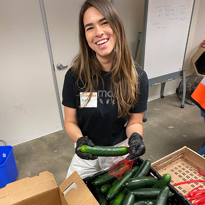 GoMacro employee holding cucumbers
