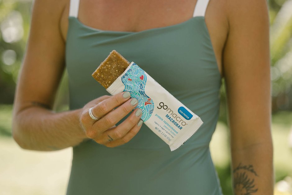 Woman holding a GoMacro Peanut Butter MacroBar