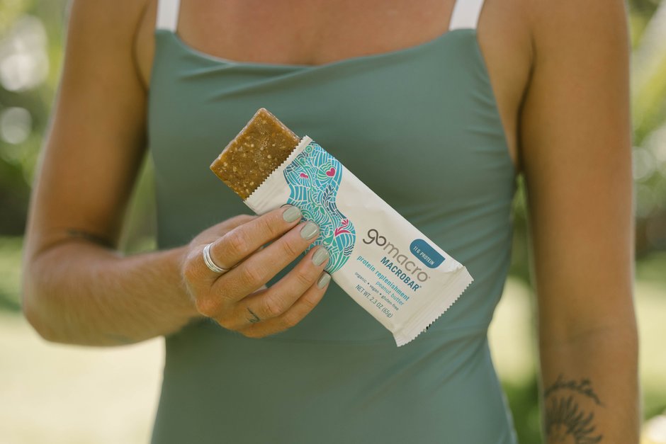 Woman holding a GoMacro Peanut Butter MacroBar