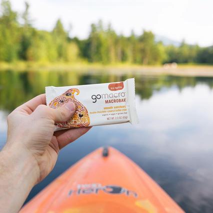 Someone holding a GoMacro Smooth Sanctuary protein bar