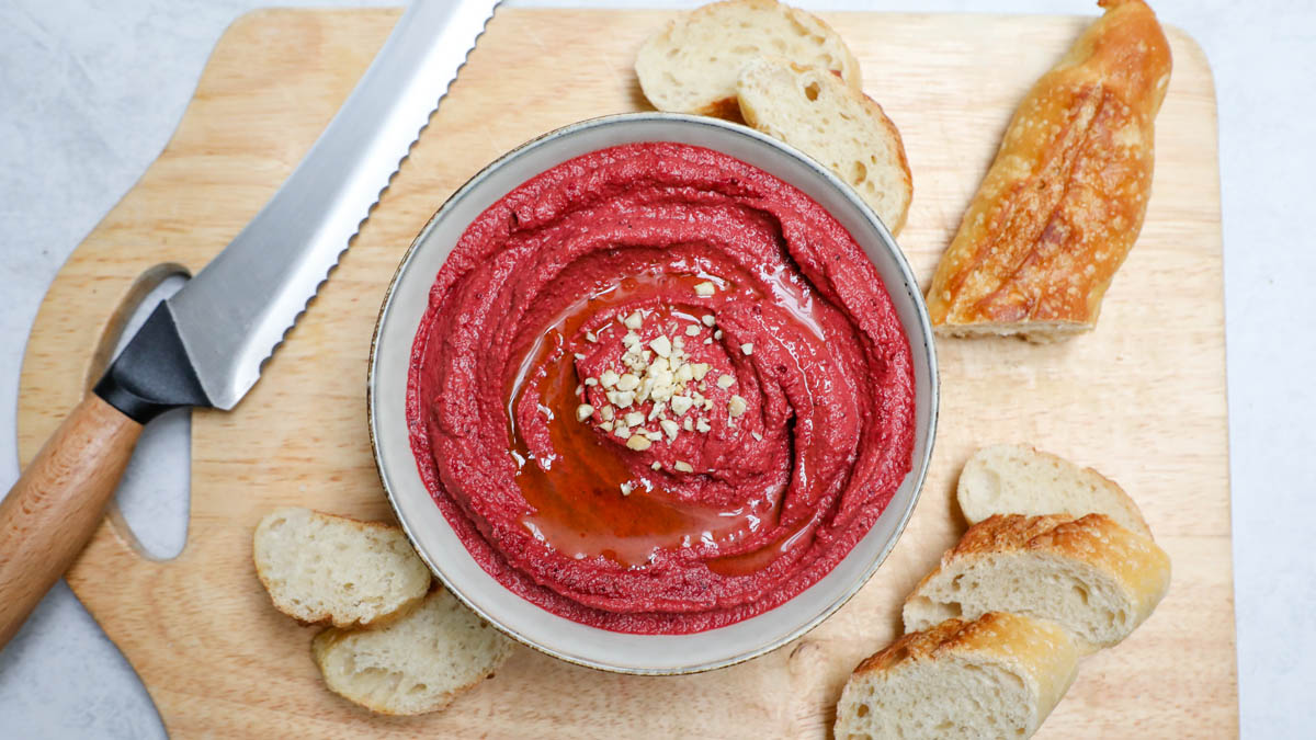 Red beet hummus and sliced bread loaf