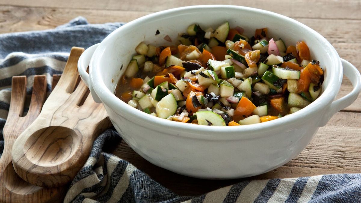 Tomato cucumber red onion salad in a bowl