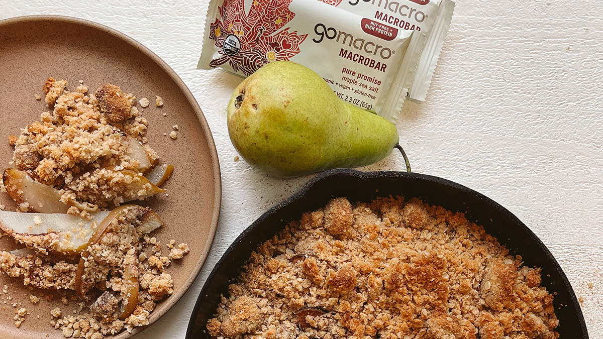 Vegan pear crisp in a pan and on a plate next to GoMacro bars