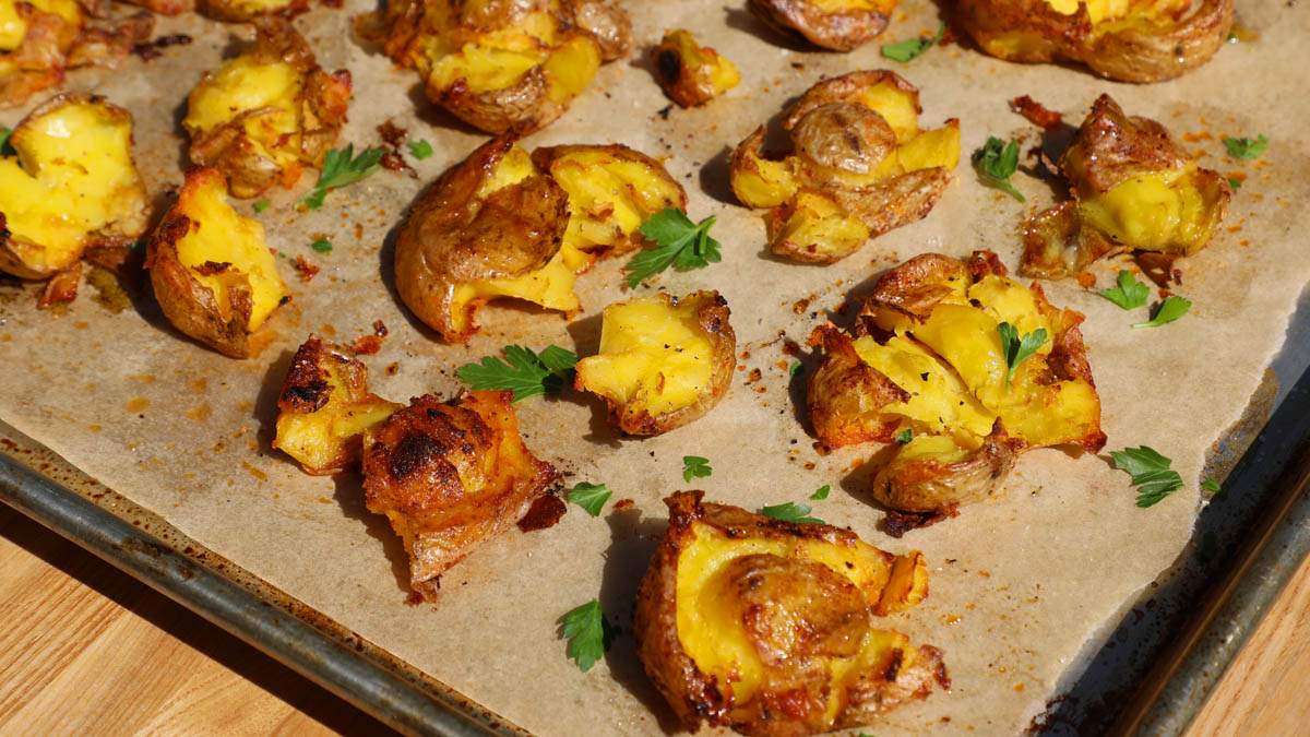 A pan of roasted smashed potatoes