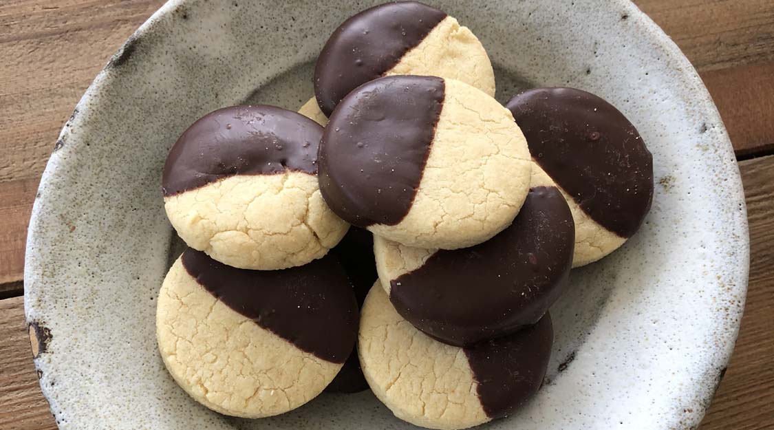 Gluten-free shortbread cookies half dipped in chocolate