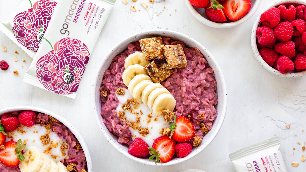 Berries and cream oatmeal topped with GoMacro sunny uplift bar
