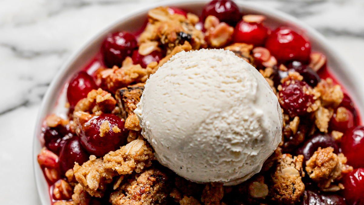 Cherries and berries cobbler topped with ice cream