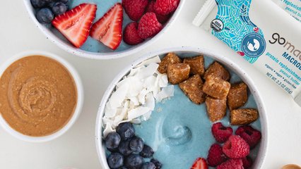 Blue coconut smoothie bowl topped with GoMacro protein replenishment bar