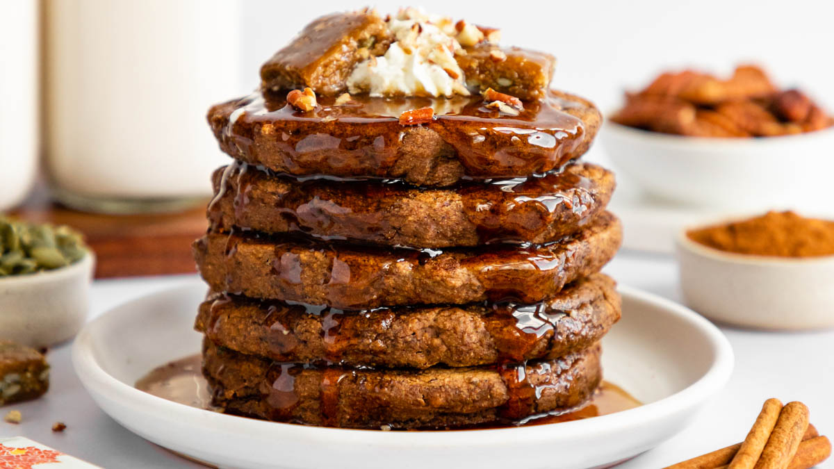 A stack of gingerbread pancakes topped with bits of GoMacro protein bars