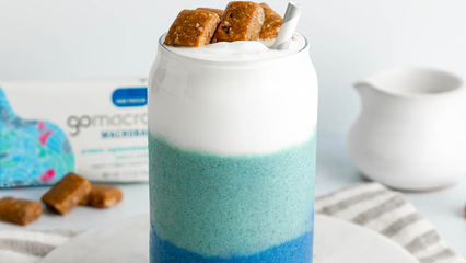 Smoothie layered with blue spirulina, coconut, and peanut butter protein bars