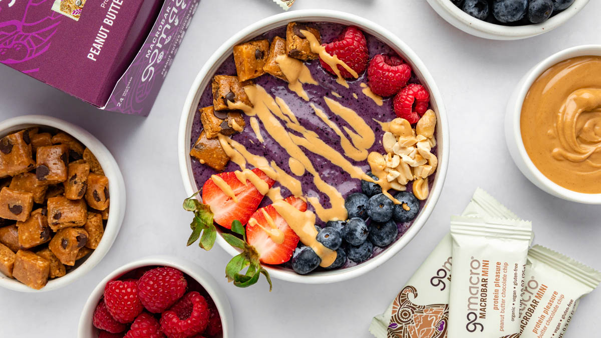 PB&J smoothie bowl topped with GoMacro peanut butter chocolate chip protein bar