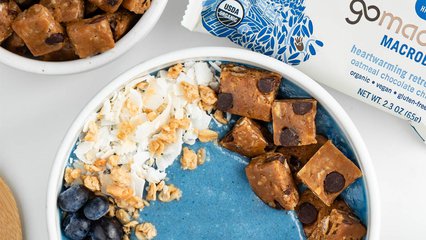 Blue oatmeal smoothie bowl topped with GoMacro oatmeal chocolate chip bar