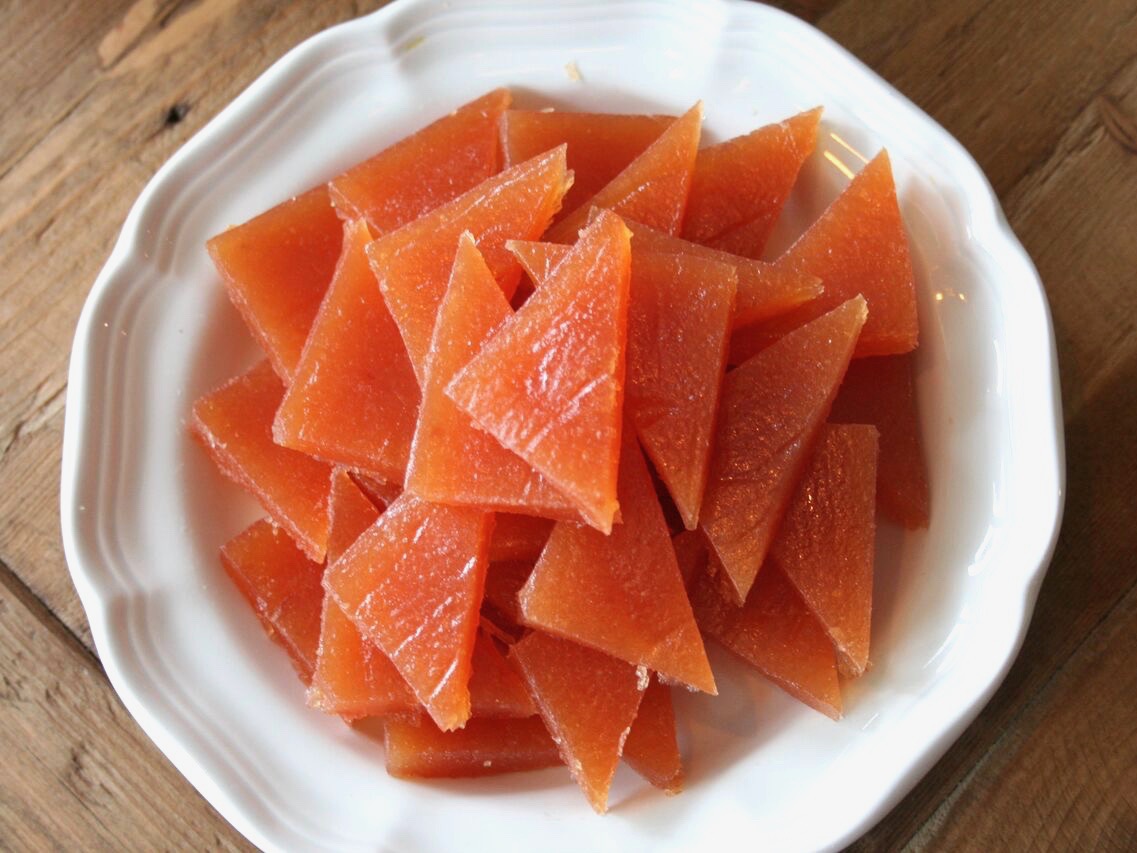 Quince paste cut up on a plate