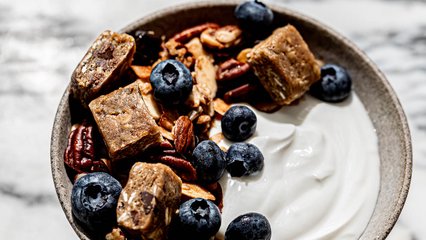 Bowl of yogurt topped with GoMacro Oatmeal Chocolate Chip MacroBar and granola