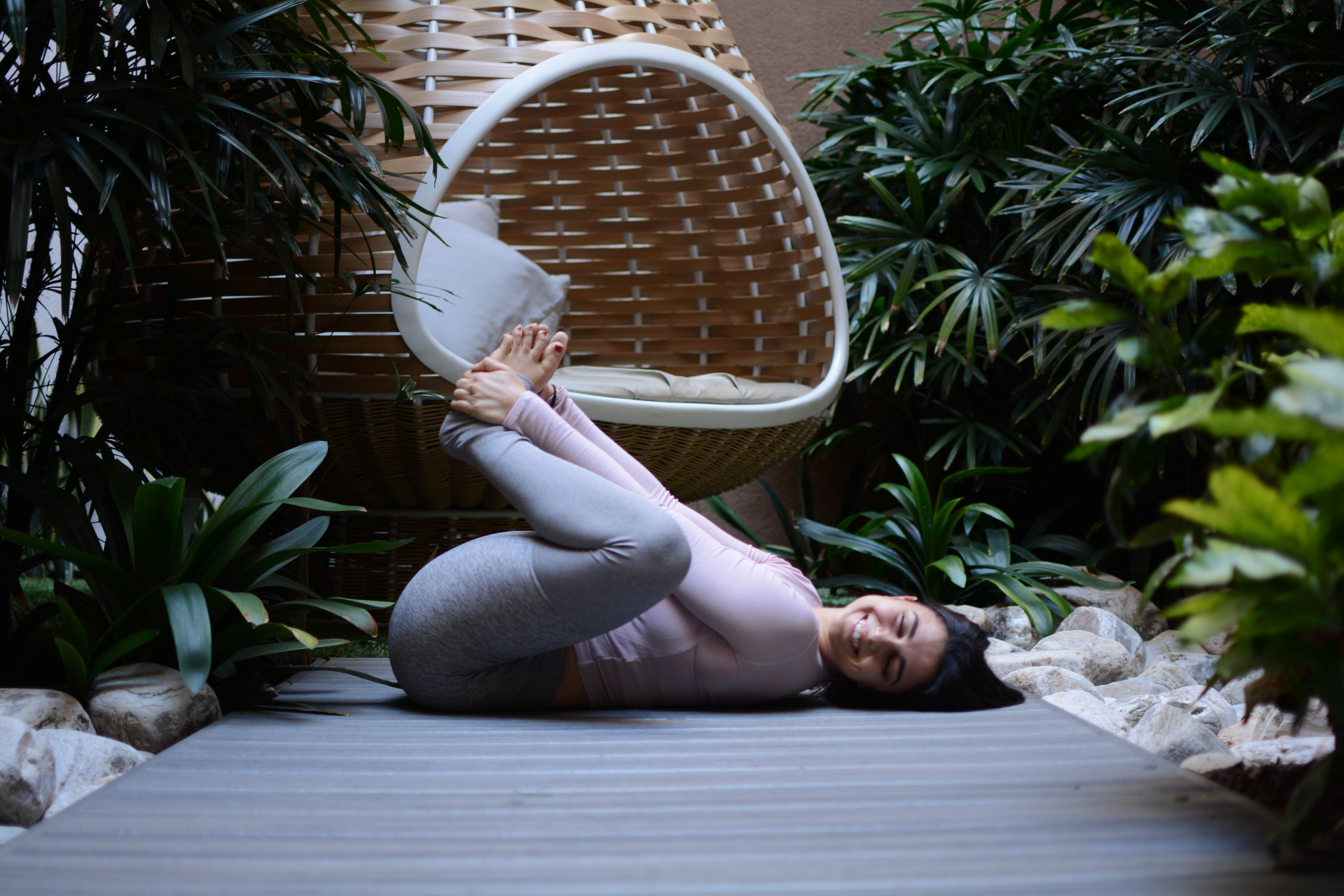 Woman in happy baby yoga pose