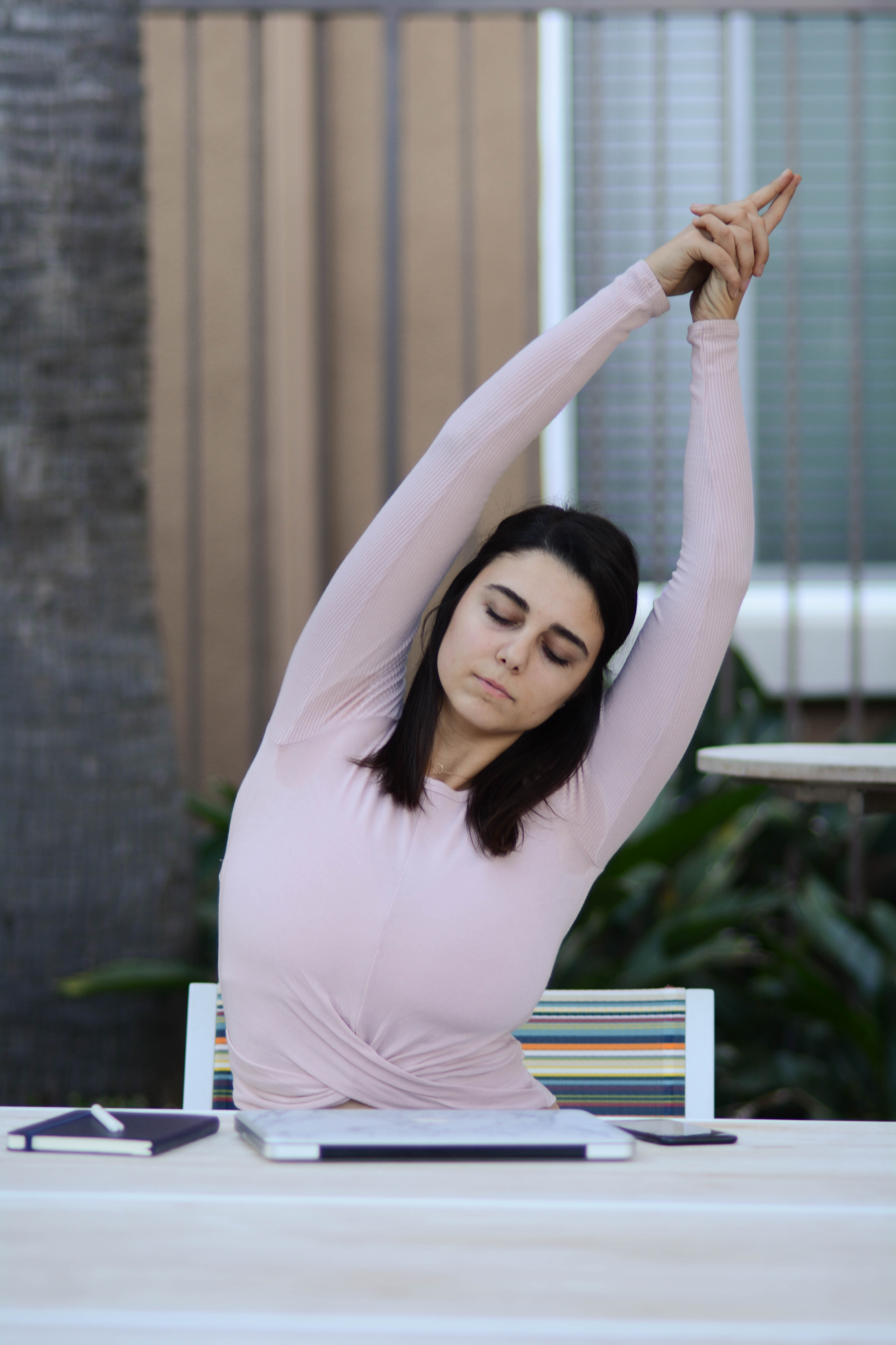 Woman doing desk yoga