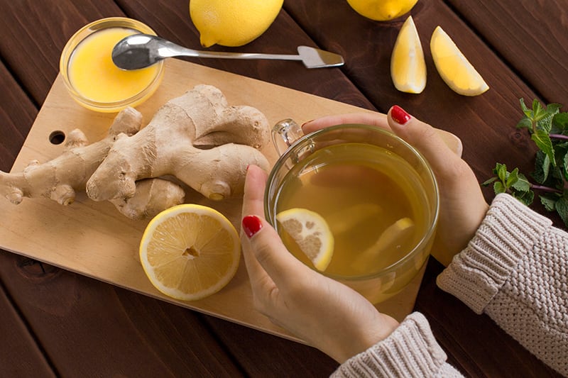 Woman holding ginger lemon tea