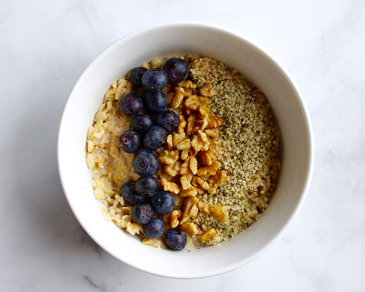 Oatmeal with blueberries, hemp seeds, and walnuts on top
