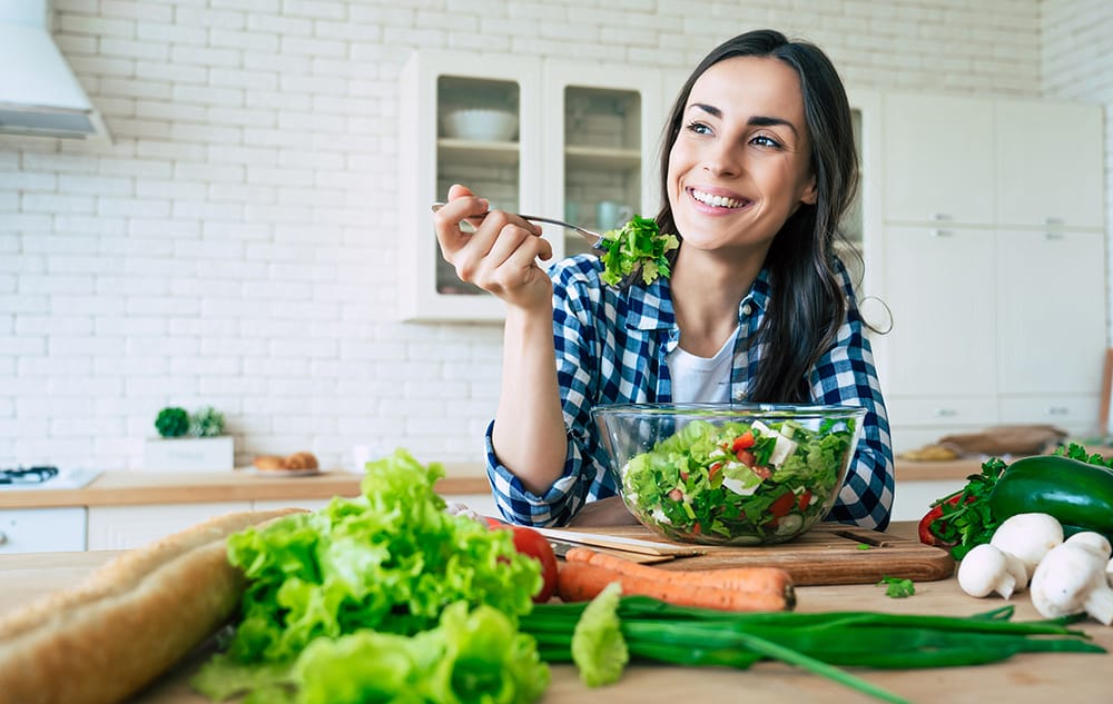 Woman eating a plant-based salad