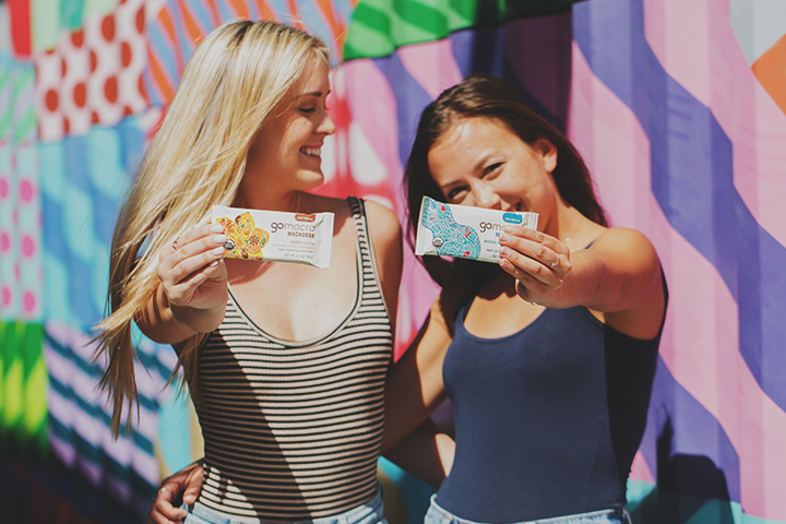 Two friends holding GoMacro MacroBars