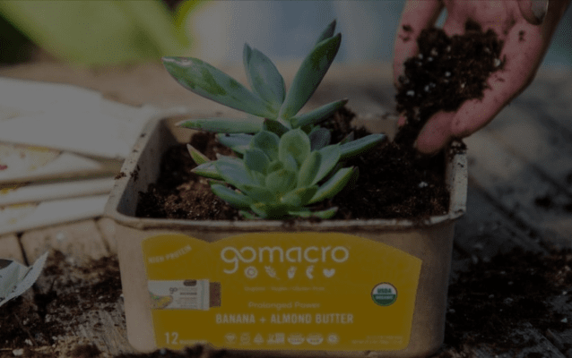 Hand putting soil into a Banana + Almond Butter MacroBar Tray