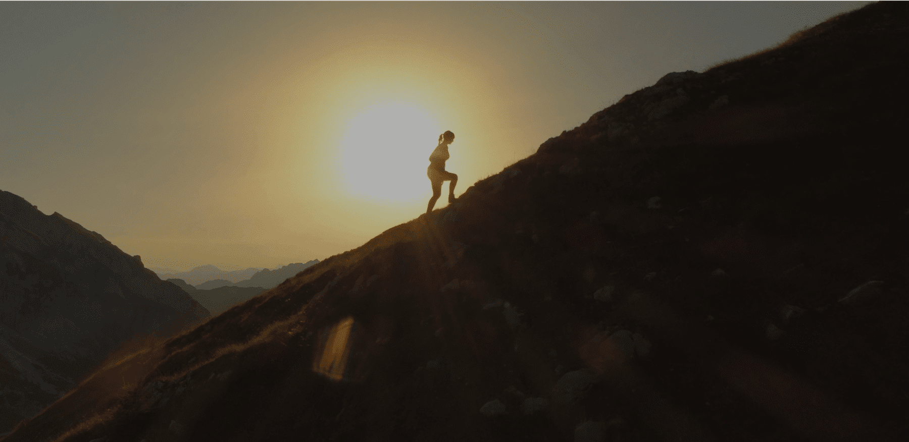 Woman walking up a mountain